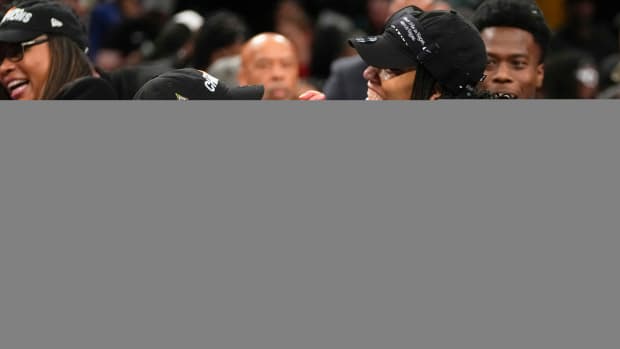 Las Vegas Aces head coach Becky Hammon holds A’ja Wilson’s hand while celebrating their WNBA Finals win over the Liberty.